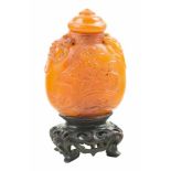 Amber snuff bottle. China. 19th century.Decorated with birds and two shishis. Heights without