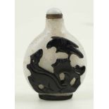 Glass snuff bottle with a black and white overlay. China. Early 20th century.Decorated with animals,