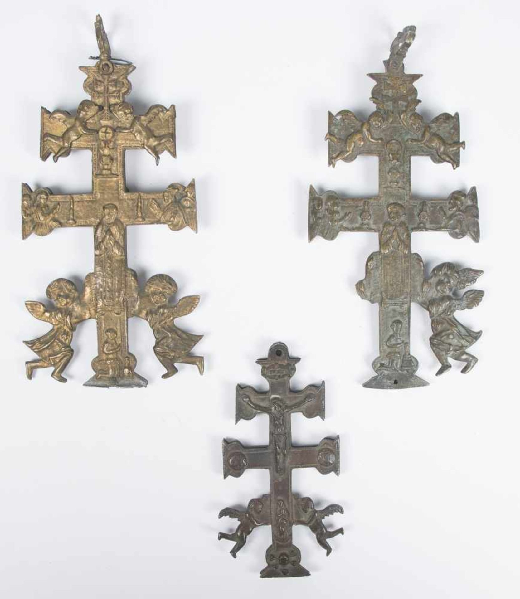 Collection of three bronze Caravaca crosses. 18th – 19th century.Two complete, double-sided crosses,