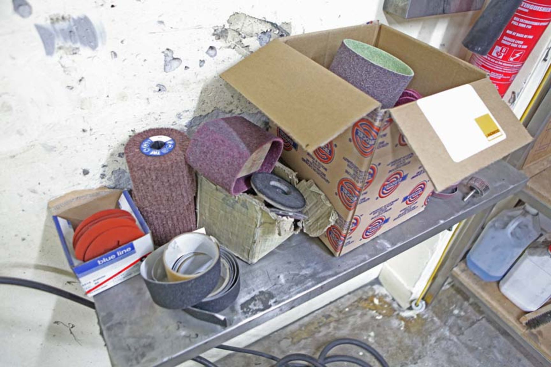 Box and shelf of assorted sanding belts