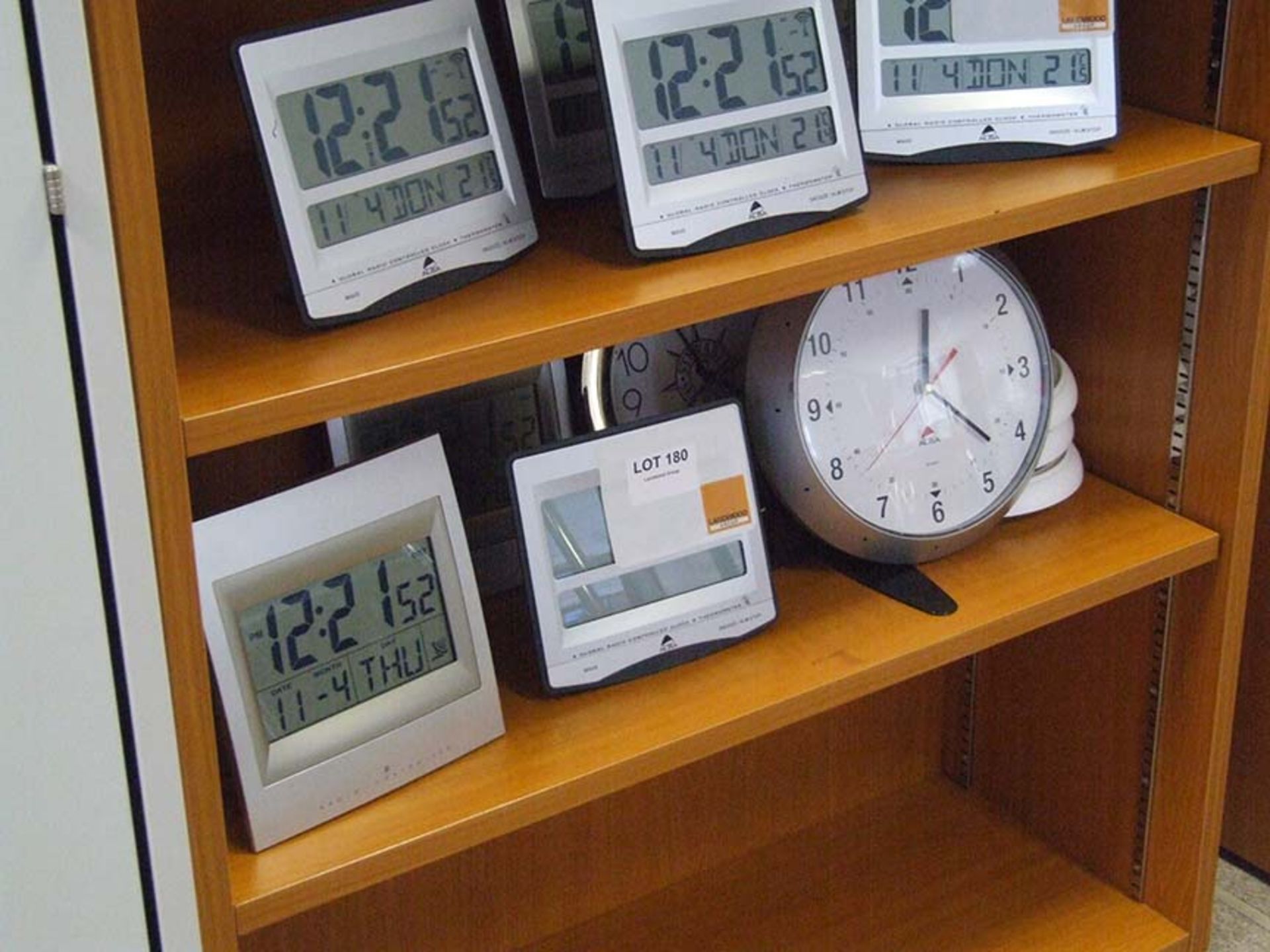 8 Clocks some digital others analogue on one shelf