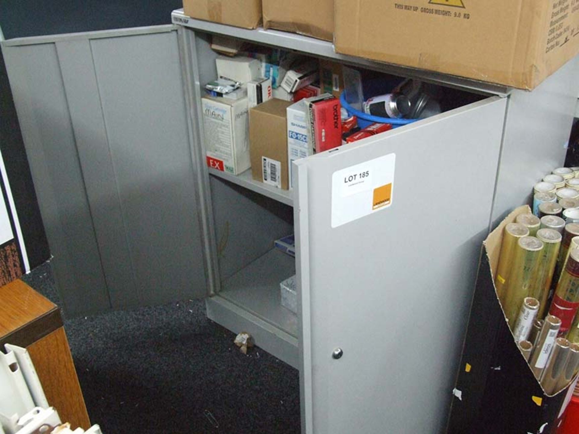 Low metal cupboard and contents to include Fax toners and A4 pockets etc
