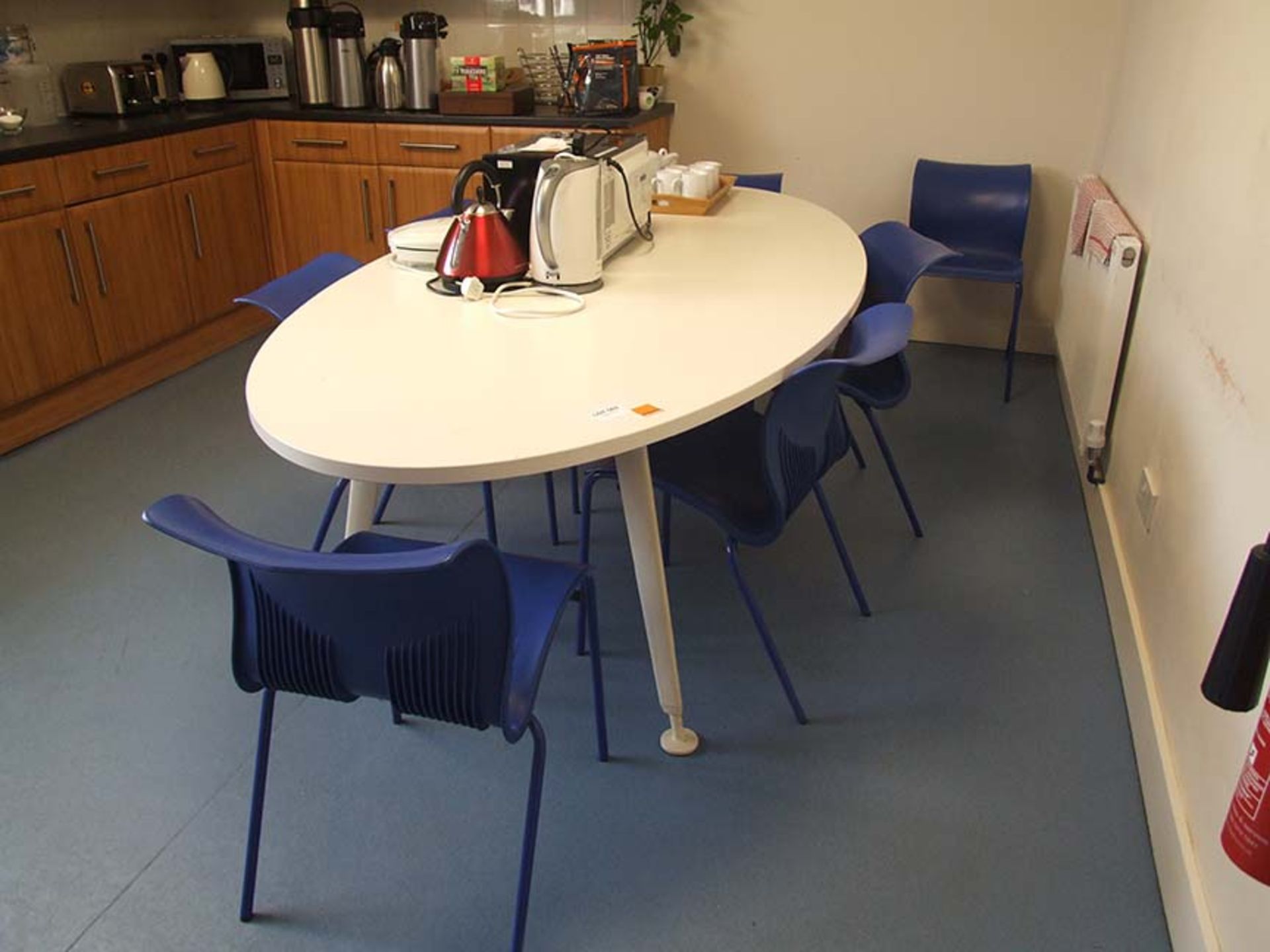 White kitchen table with 7 blue chairs
