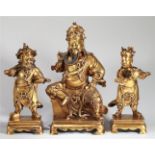 CHINESE GILT BRONZE FIGURES OF GUAN GONG AND TWO GUARDIANS