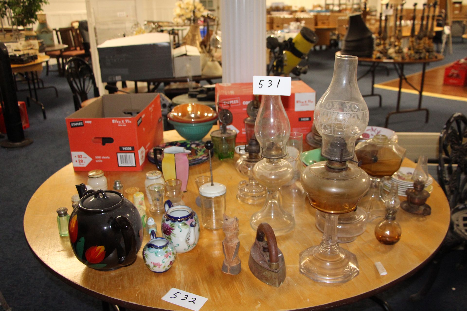 Lot misc tea pots, kerosene lamps, glasswares etc on table