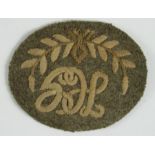 Cloth Badge: "HG" in wreath - Hotchkiss Gunner WW1 embroidered arm badge (Edwards & Langley 58A)