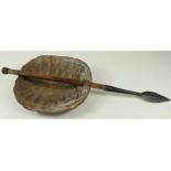 Tribal tortoiseshell shield with incorporated stabbing spear, circa 1880, shell dimensions 24cm x