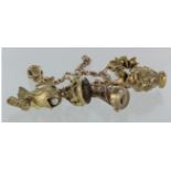 9ct solid charm bracelet with trigger clasp, six charms and smoky quartz set fob, weight 57.1g