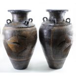 Pair of large floor standing pots, both with four handles, decorated with a floral and brick