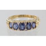 18ct yellow gold tanzanite and diamond carved head riing, size O, weight 4.7g