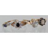 Four rings to include 18ct sapphire and diamond three stone ring, 9ct sapphire and diamond cluster