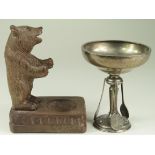 Tennis interest. Silver tennis trophy with pedestal base surrounded by three tennis rackets,