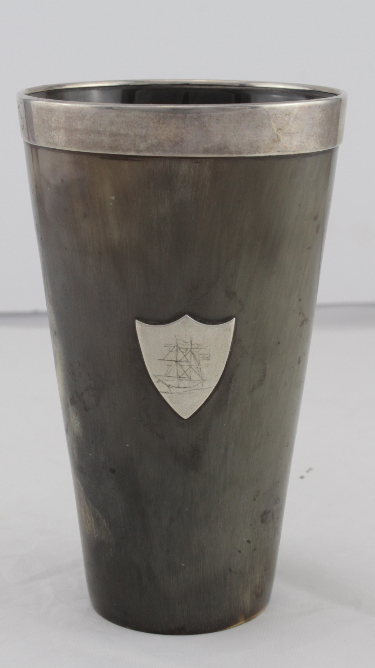 Horn beaker with silver rim and silver shield to side depicting a tall ship, hallmarked 'London