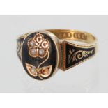 15ct yellow gold mourning ring set with half pearls in a floral design, some missing. Size O, weight