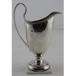 Silver milk jug on a square base, hallmarked 'S.I Ld, Birmingham 1894' (Stokes & Ireland Ltd),
