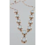 9ct rose gold Y shaped necklace with ten created opal oval stones, 18" long, 11.7g.