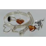 Silver. A group of silver items, comprising bangle, bracelet with locket, ring with stone, a