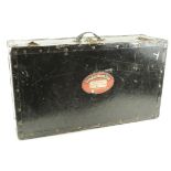 Black luggage case with 'Cunard White Star' label to front, label reads 'E. Nash, Aquitania,