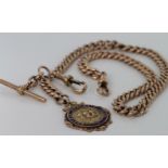 9ct gold hallmarked "T" bar pocket watch chain with a 9ct sporting medal attached (dated 1920) fob