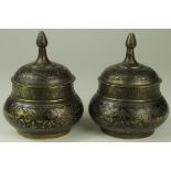 Two Ottoman style ornately decorated pots (possibly bronze), height 12cm, diameter 10cm approx.