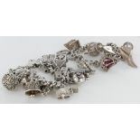 Two silver charm bracelets, both with a selection of charms attached. Total weight 143.2g approx.