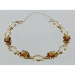14ct yellow gold bracelet set with oval citrine alternate links, safety chain, weight 11.6g