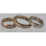Three 9ct yellow gold spinel full eternity rings, size T, weight 2.9g. Size M, weight 2.1g. Size