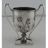 Silver double handled cup / trophy, with embossed floral decoration, hallmarked 'HW&Co. Ld, London