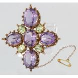 Yellow metal, tested as 18ct yellow gold, amethyst and peridot brooch with safety chain, weight 20.