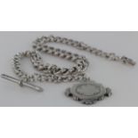 Silver "T" bar pocket watch chain with sporting fob attached. Approx length 36.5cm, weight 75.7g