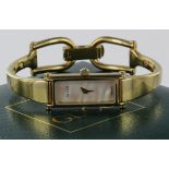 Ladies Gucci wristwatch The rectangular mother of pearl dial on a yellow metal bangle style