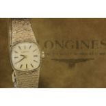In its original box, Ladies 9ct cased "Longines" wristwatch (circa 1980) on a 9ct integral bracelet,