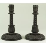 Pair of ornately carved oak candlesticks, height 19.5cm approx.