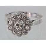Tested as 18ct white gold diamond daisy cluster ring, total diamond weight calculated as approx.