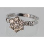 Platinum seven stone diamond cluster ring with diamond set shoulders, total diamond weight approx.