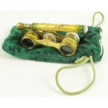 Fine pair of enamel opera glasses with handle, foliate decoration, contained in a green pouch