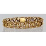 Ladies yellow metal (tests as approx 20ct) ornate bracelet with safety chain, approx 18cm long,