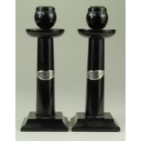 Pair of ebony candlesticks, with small silver plaques, circa 1927, height 19cm approx.