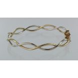 9ct two colour gold hinged wavy bangle with box clasp and safety catches, weight 8.7g