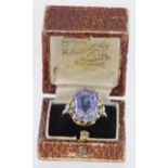 18ct yellow gold ring set with large cushion shaped sapphire with single diamond on each shoulder,