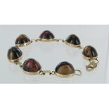 9ct gold tigers eye seven stone bracelet, 20cm long, weight 27.9g