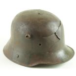 Imperial German Stalhelm M16 camo tin helmet, battle damaged, aged camo paint still visible.