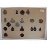 Cap Badges - Plastic WW2 Economy cap badges, mounted on a board. Sold as seen (19)