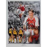 Former Arsenal Captain Kenny Sansom signed framed and mounted 16 x 12" image holding aloft the