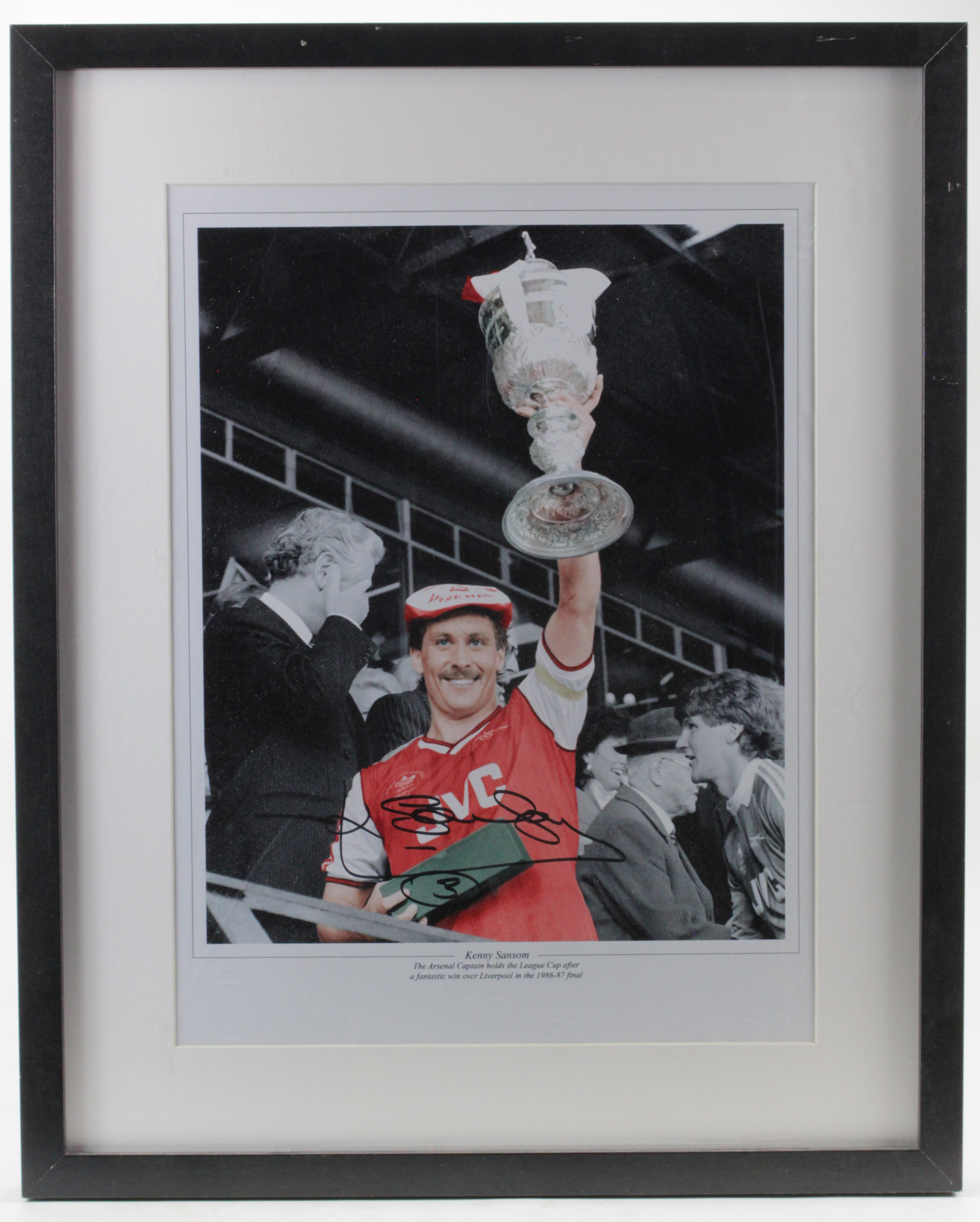 Former Arsenal Captain Kenny Sansom signed framed and mounted 16 x 12" image holding aloft the - Image 2 of 2