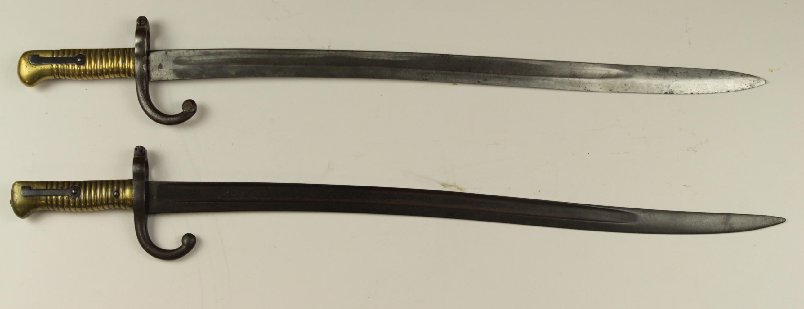 Chasspot Model 1866 Sabre bayonets. No scabbards. One with replacement spear point blade. Both in