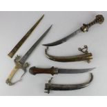 Eastern Daggers 1) An Arab Jambiya. Wooden grip in its silver scabbard. Curved blade 8". (Not a