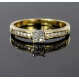 9ct gold ring set with four tension set princess cut diamonds and diamond set shoulders, total