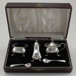 Silver three-piece cruet set, with two spoons, hallmarks none matching, contained in a fitted case