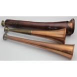 Three copper hunting horns, one in a leather holder, 27cm, 23cm & 22cm approx.